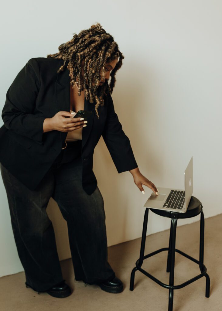 website designer working on laptop for wedding photographer brand and website design